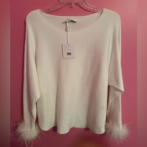 With tags, never worn, white sweater with feather trimmed sleeves